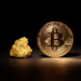 A shiny gold Bitcoin coin stands upright on a dark surface, illuminated to highlight its intricate design. To its left, a small piece of raw gold rests, also brightly lit against the black background. | GoldZeus.com