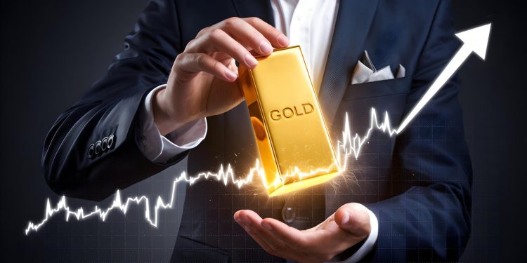 A person in a suit holds a large gold bar labeled "GOLD," illuminated by a bright, glowing light. A white, upward-trending graph line runs across the image, visually answering the question: Why Invest in Gold? It symbolizes financial growth and investment success. | GoldZeus.com